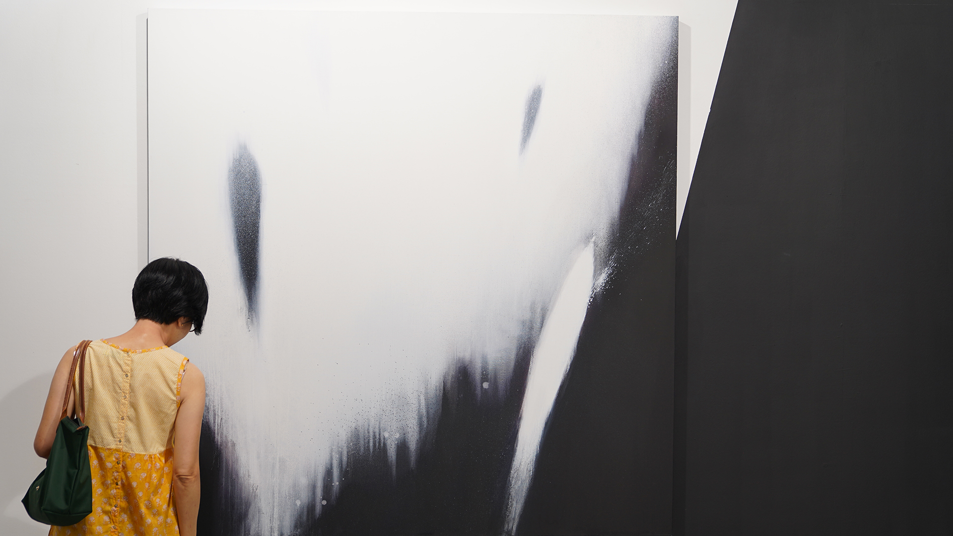 A visitor views an artwork by local artist Luke Heng.
